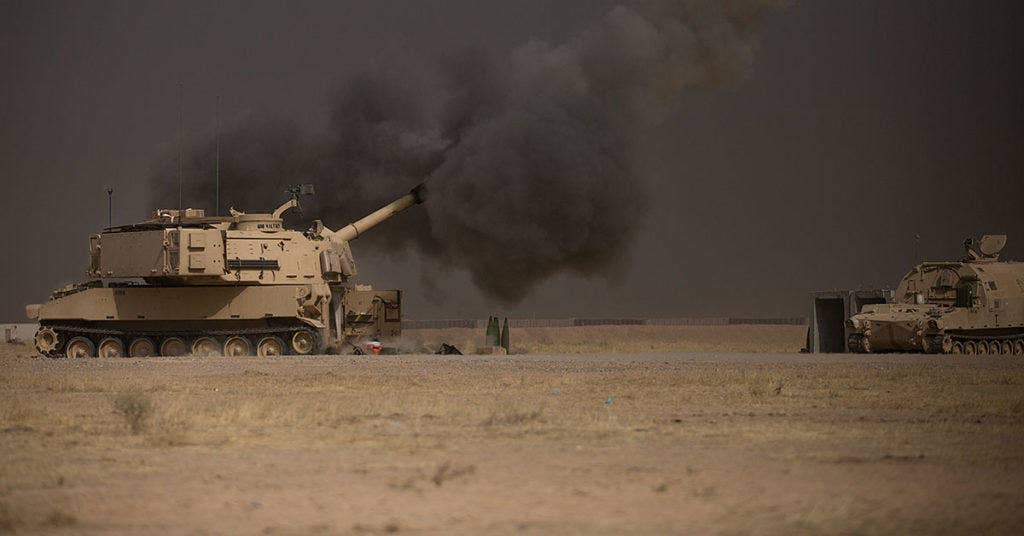 A U.S. Army M109A6 Paladin conducts a fire mission at Qayyarah West, Iraq, in support of the Iraqi security forces' push toward Mosul, Oct. 17, 2016. The support provided by the Paladin teams denies the Islamic State of Iraq and the Levant safe havens while providing the ISF with vital artillery capabilities during their advance. The United States stands with a Coalition of more than 60 international partners to assist and support the Iraqi security forces to degrade and defeat ISIL. (U.S. Army photo by Spc. Christopher Brecht)