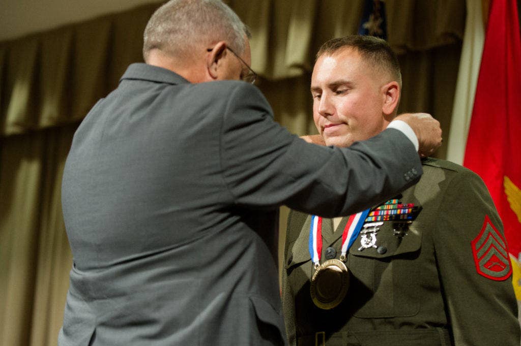 Marine Staff Sgt. Jared C. Coons receives the 2012 U.S. Marine Corps Spirit of Hope Award during the 2012 Spirit of Hope Award Ceremony at the Pentagon Library, Nov. 19, 2013. (DoD Photo by Mass Communication Specialist 1st Class Daniel Hinton)