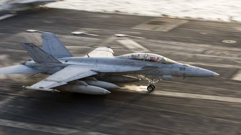 An F/A-18F Super Hornet assigned to the Fighting Swordsmen of Strike Fighter Squadron (VFA) 32 makes an arrested landing on the flight deck of the aircraft carrier USS Dwight D. Eisenhower (Ike). Ike and its Carrier Strike Group are deployed in support of Operation Inherent Resolve. | U.S. Navy photo by Petty Officer 3rd Class Andrew J. Sneeringer