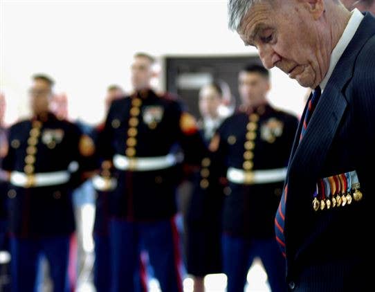 1st Lt. Joseph Owen (Retired) bows his head during the invocation of his Silver Star ceremony, 59 years after the actions where he earned it, April 24, 2009. (Marine Corps photo)