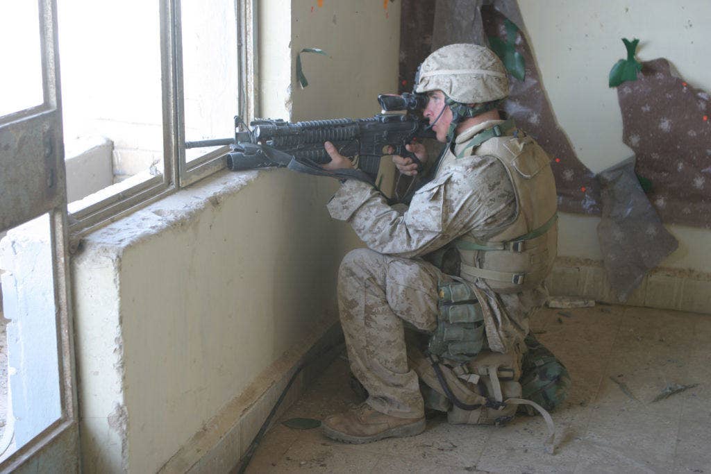A U.S. Marine watches for anything suspicious from a building in Fallujah, Iraq, during Operation al Fajr (New Dawn) on Nov. 10, 2004. The Marine is assigned to 1st Battalion, 8th Marines, 1st Marine Division. (DoD photo by Lance Cpl. Trevor R. Gift, U.S. Marine Corps.)