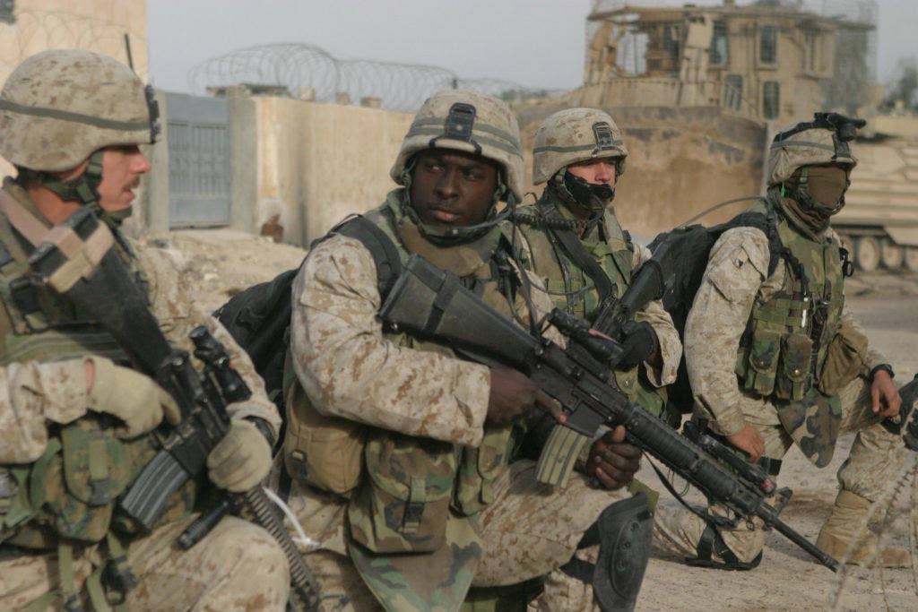 041126-M-5191K-005U.S. Marines prepare to step off on a patrol through the city of Fallujah, Iraq, to clear the city of insurgent activity and weapons caches as part of Operation al Fajr (New Dawn) on Nov. 26, 2004. The Marines are (from left to right) Platoon Sergeant Staff Sgt. Eric Brown, Machine Gun Section Leader Sgt. Aubrey McDade, Radio Operator Cpl. Steven Archibald, and Combat Engineer Lance Cpl. Robert Coburn. All are assigned to 1st Battalion, 8th Marine Regiment, 1st Marine Division conducting security and stabilization operations in the Al Anbar Province of Iraq. (DoD photo by Staff Sgt. Jonathan C. Knauth, U.S. Marine Corpss)