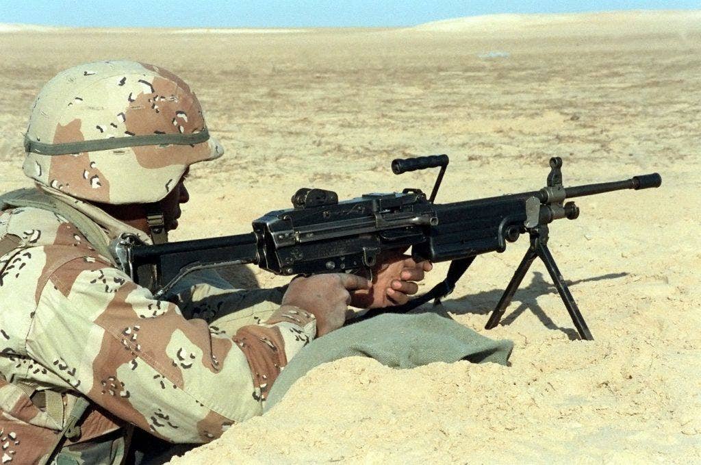 A member of Co. A., Marine Barracks, Eighth and Eye Streets, mans an M-249 squad automatic weapon at the 2nd Marine Division Combat Operations Center (COC) during Operation Desert Storm on Feb. 8, 1991. (Photo: U.S. Marine Corps Staff Sgt. J. R. Ruark)