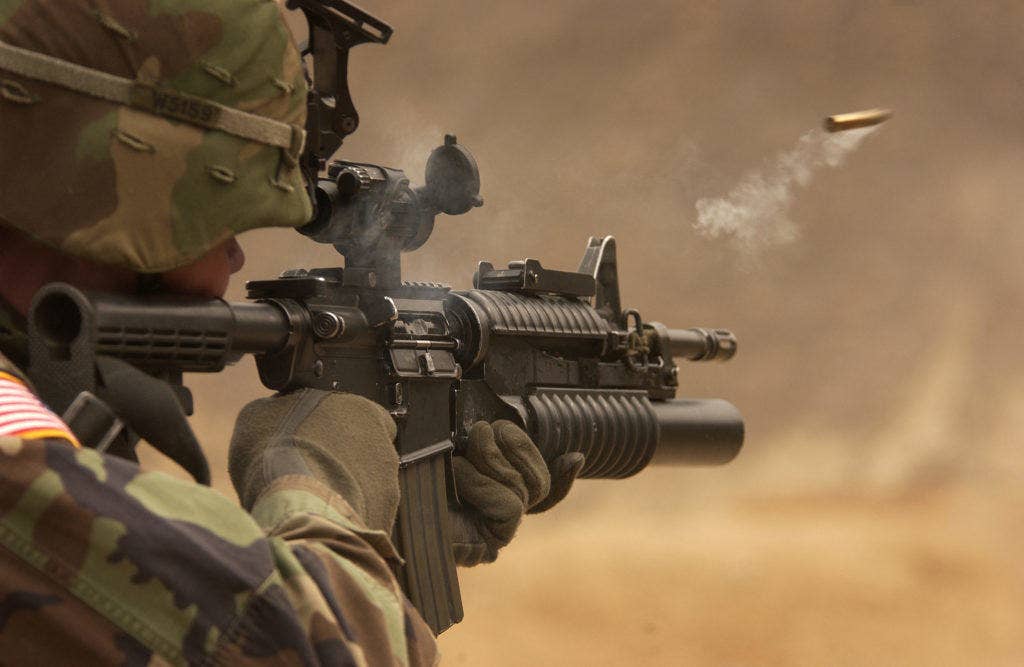 U.S. Army PFC Michael Freise fires an M4 carbine rifle during a firing exercise. | US Army photo by Staff Sgt. Suzanne M. Day