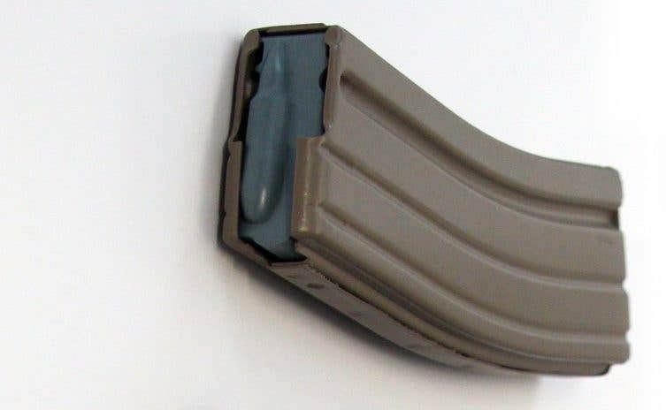 The Army's new magazine, dubbed the Enhanced Performance Magazine , is currently being issued to units through the supply system. It is optimized for use with the Army's steel tipped 5.56mm small arms cartridge, the M855A1, in the M4/M4A1 and M16. The EPM recognizable by its blue-grey follower. | U.S. Army Photo by Rob Hovsepian