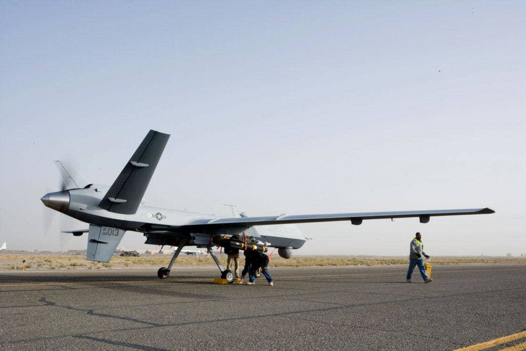 Aircrews perform a preflight check on an MQ-9 Reaper before it takes of for a mission. (Photo from DoD)