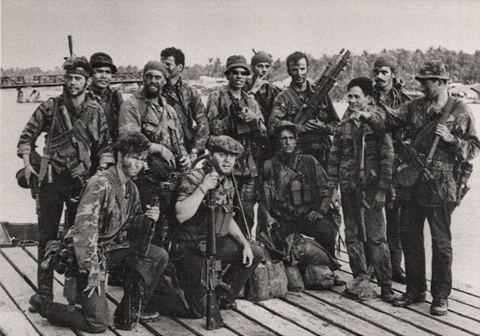 Standing, left to right: PK Barnes, Kit Carson Scout, Happy Baker, Mike Collins, Tong, Randal Clayton, Jim McCarthy, Ah, Mike Capelnor, Lou DiCroce, Kneeling: Allen Vader, Clint Majors, David Shadnaw. (Navy SEAL Museum)