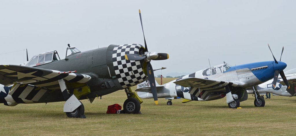 The P-51 and P-47 sit side-by-side. (Photo by Alan Wilson via WikiMedia Commons)