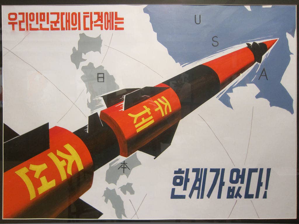 A North Korean propaganda poster depicting a missile firing at the United States. | Via Flickr.