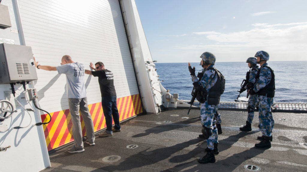Coast Guard members participate in a counter-piracy exercise with Chinese sailors from Chinese navy multirole frigate Hengshui (572) aboard the Coast Guard Cutter Stratton (WMSL 752), during Rim of the Pacific exercise 2016. (U.S. Coast Guard photo by Petty Officer 3rd Class Loumania Stewart)