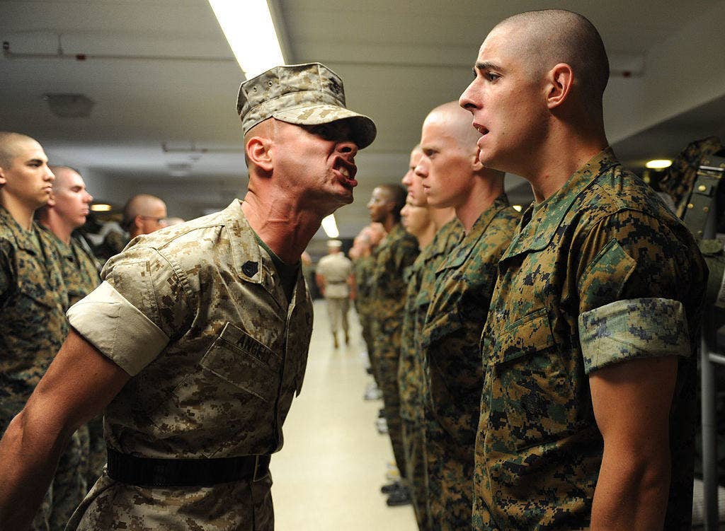 Gunnery Sergeant Shawn D. Angell gently corrects a trainee. (Photo: U.S. Marine Corps)
