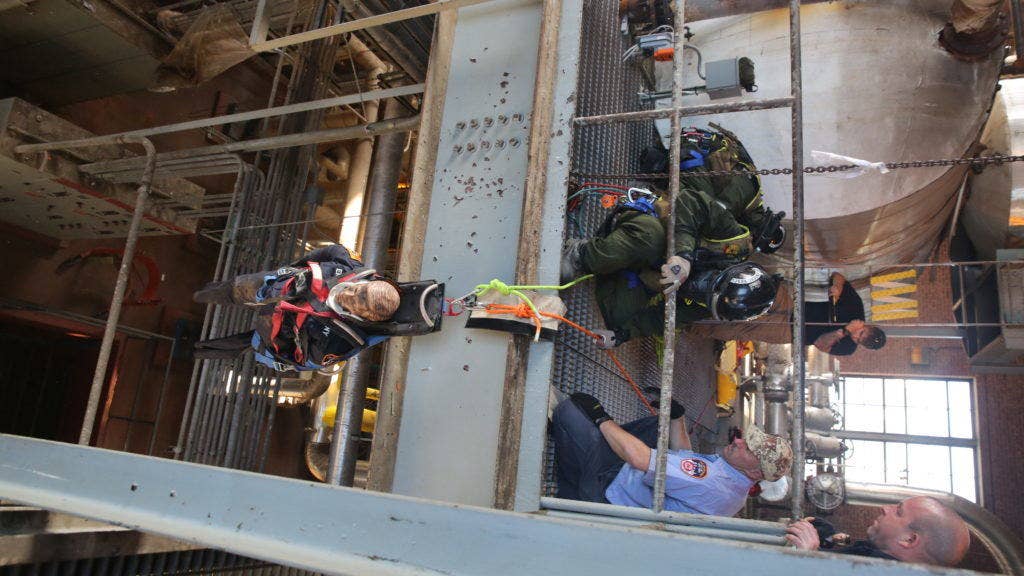 U.S. Marines with Technical Rescue Platoon, Chemical Biological Incident Response Force (CBIRF) rescue simulated casualties using vehicle extrication and high angle rescue techniques as part of a final training exercise with Fire Department of New York (FDNY) at Randall's Island, N.Y., Sept. 15, 2016. (Photo: Marine Corps Lance Cpl. Maverick S. Mejia)