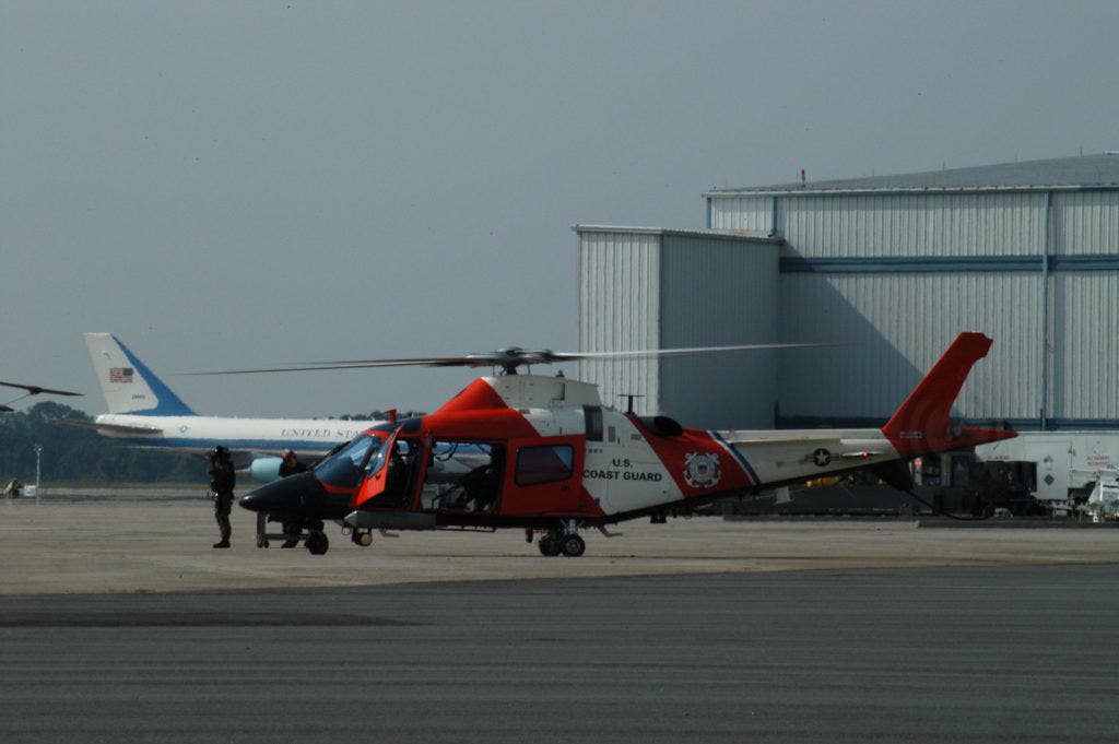 A Coast Guard MH-68 Sting Ray helicopter crew prepares to take off for a patrol of the Savannah River to provide security during the G8 Summit while Air Force One sits in the background. USCG photo by PA3 Ryan Doss
