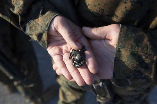The title Marine and the coveted Eagle, Globe and Anchor emblem is earned only by those who are imbued with the Corps' core values. | US Marine Corps photo by Cpl. Vanessa Austin)