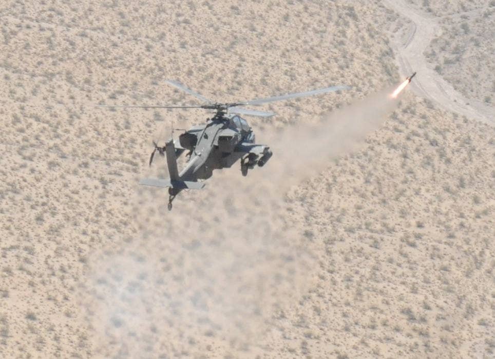 An Apache attack helicopter assigned to the 3rd Battalion, 501st Aviation Regiment, 1st AD Combat Aviation Brigade also known as 'Task Force Apocalypse', fires a Hellfire missile Sept. 11, 2014 at Fort Irwin, California. (US Army photo by: Sgt. Aaron R. Braddy/Released)