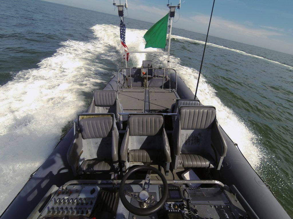 An unmanned rigid-hull inflatable boat operates autonomously during an Office of Naval Research (ONR)-sponsored demonstration of swarmboat technology held at Joint Expeditionary Base Little Creek-Fort Story. During the demonstration four boats, using an ONR-sponsored system called CARACaS (Control Architecture for Robotic Agent Command Sensing), operated autonomously during various scenarios designed to identify, trail or track a target of interest. (U.S. Navy photo by John F. Williams/Released)