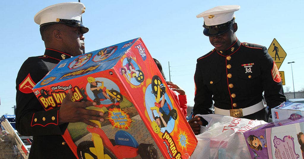 Lance Cpl. Gentres Anderson, from Pensacola, Florida, and Sgt. Sheldon Curry, from Montgomery, Alabama, help bring toys to the donation bins for the Marines' Toys for Tots Program in Montgomery, Alabama, Dec. 13, 2014. (Photo U.S. Marine Corps)