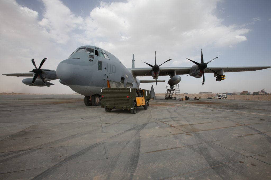 The Harvest Hawk equipped KC-130J rests on the runway at Camp Dwyer, Afghanistan, March 24. The one-of-a-kind Harvest Hawk system includes a version of the target sight sensor used on the AH-1Z Cobra attack helicopter as well as a complement of four AGM-114 Hellfire and 10 Griffin missiles. This unique variant of the KC-130J supports 2nd Marine Aircraft Wing (Forward) in providing closer air support and surveillance for coalition troops on the ground in southwestern Afghanistan. Plans for a 30mm chain gun are in the works. (USMC photo)