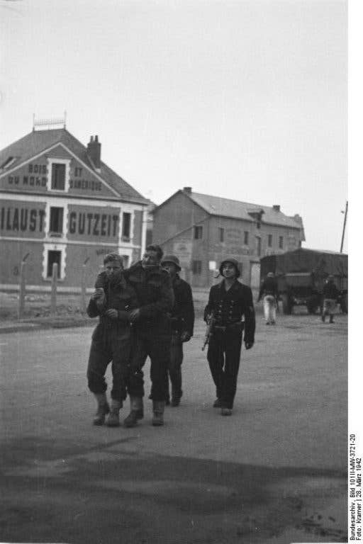 British prisoners are escorted by German troops in the final hours of the St. Nazaire raid. (Photo: German army archives)