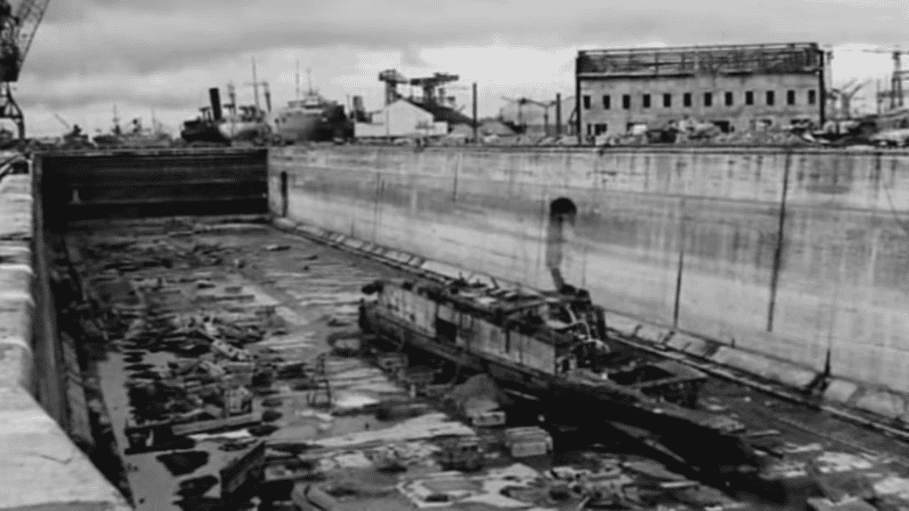The remains of the HMS Campbeltown sit in the Normandie dry dock after a bomb in the ship's hull rendered the docks unusable. (Photo: YouTube/993ti)