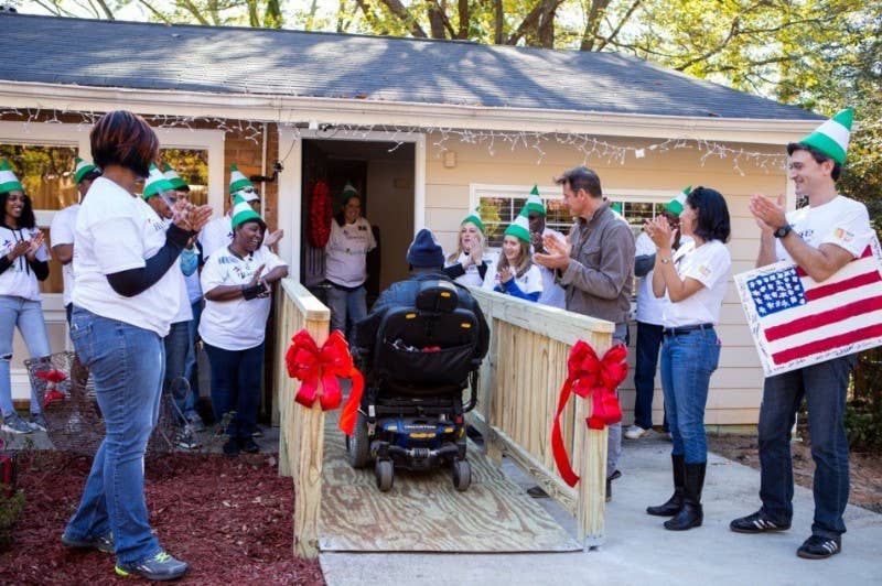 Sears celebrity designer Ty Pennington (third from right) with Sears and Rebuilding Together volunteers look on as a veteran resident is the first to use an accessibility ramp built by the Sears Heroes at Home for the Holidays program at the Open Hearts Residential Living Center for veterans in Decatur, Ga., founded by U.S. Army veteran Missy Melvin. As part of its long-standing commitment to supporting veterans and military families, Sears brought back its Heroes at Home program for the holiday season to immediately assist in building dozens of wheelchair accessibility ramps at the homes of low-income veterans before Christmas. (PRNewsFoto/Sears, Roebuck and Co.)