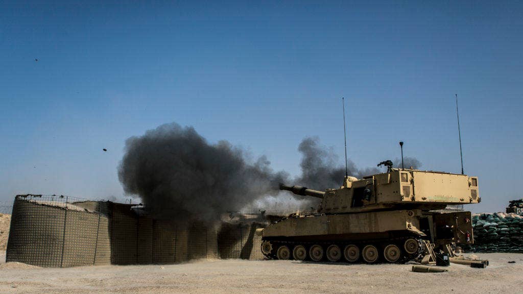 U.S. Soldiers with Battery C, 4th Battalion, 1st Field Artillery Regiment, 1st Armored Division, Task Force Al Taqaddum, fire an M109A6 Paladin howitzer during a fire mission at Al Taqaddum Air Base, Iraq, June 27, 2016. The strikes were conducted in support of Operation Inherent Resolve, the operation aimed at eliminating the Islamic State of Iraq and the Levant, and the threat they pose to Iraq, Syria, and the wider international community. (U.S. Marine Corps photo by Sgt. Donald Holbert)