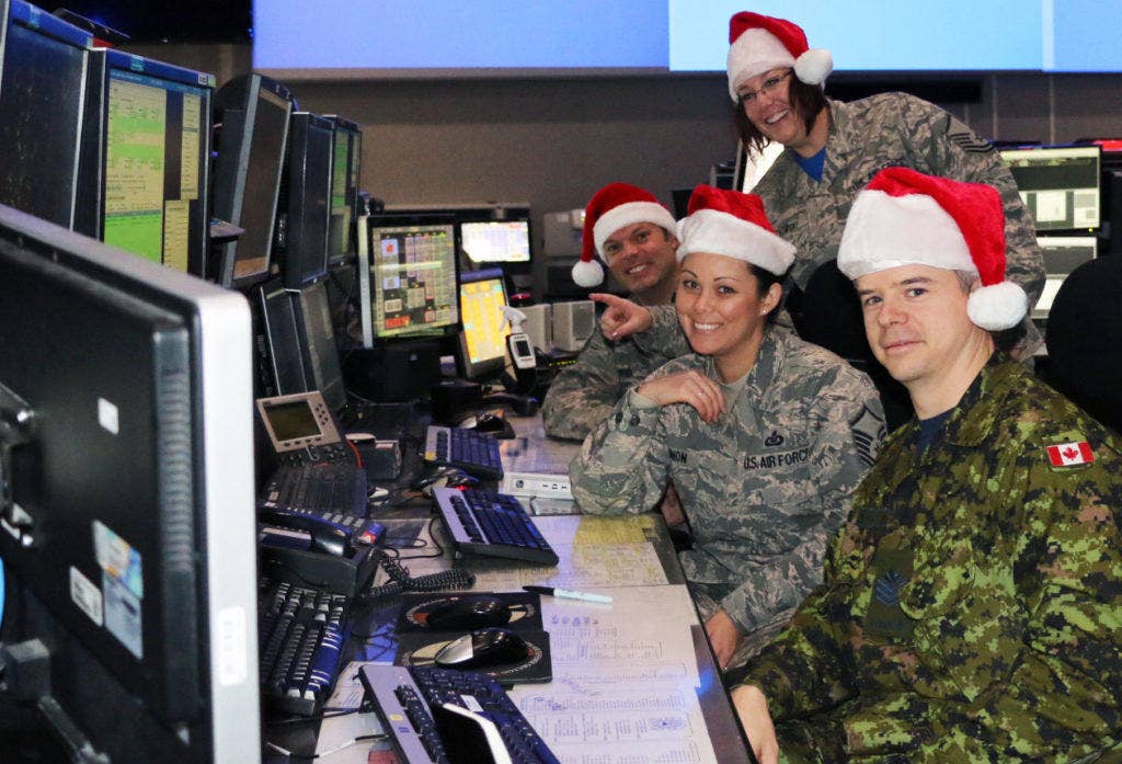 Eastern Air Defense Sector (EADS) personnel conduct training in preparation for Santa tracking operations at their headquarters in Rome, N.Y. on Dec. 11, 2016. Pictured from front to back, are: Sgt. Thomas Vance of the Royal Canadian Air Force, a member of EADS Canadian Detachment; and Master Sgt. Michelle Gagnon, Master Sgt. Lena Kryczkowski (standing) and Master Sgt. Shane Reid, all members of the New York Air National Guard's 224th Air Defense Squadron. (DOD photo)