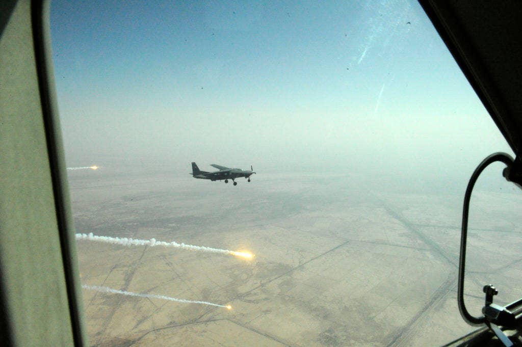 An Iraqi air force pilot from the 3rd Squadron fires of some flares from an Iraqi air force Cessna AC-208 above the Aziziyah test fire range in Iraq on Nov. 8. (Photo: U.S. Army Sgt. Brandon Bolick)