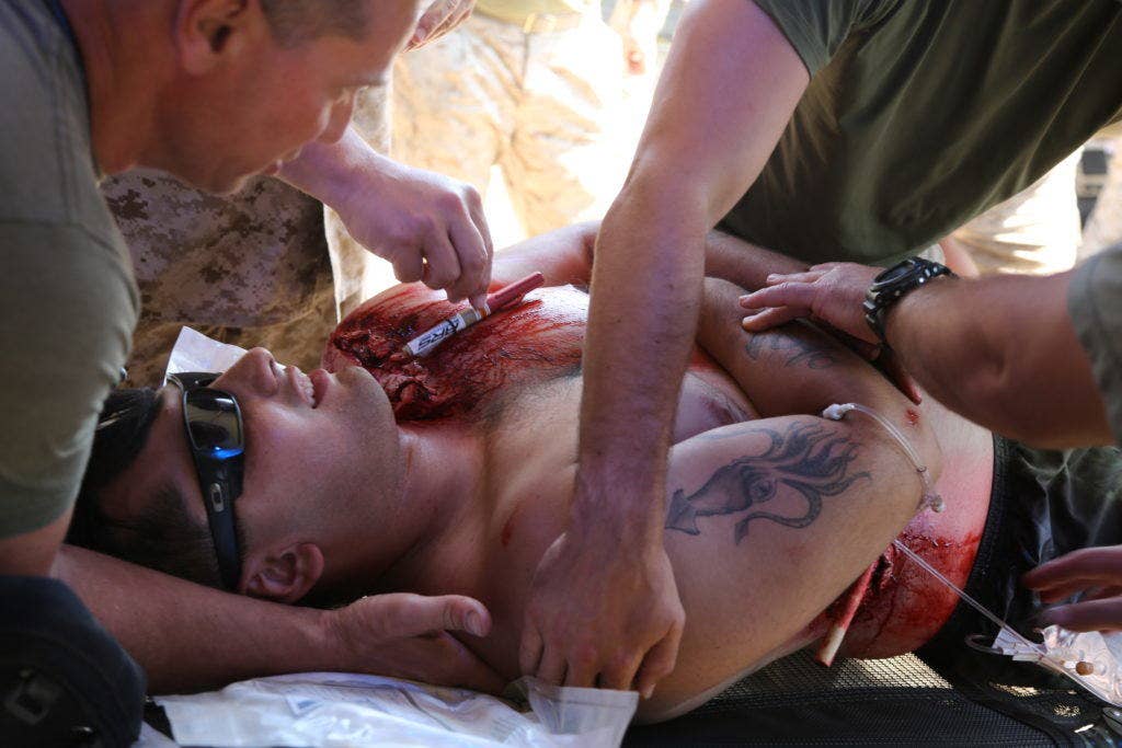 U.S. Navy corpsmen from 1st Medical Battalion assess the extent of injuries on a victim of simulated combat-related trauma aboard Camp Pendleton. (U.S. Marine Corps photo by Pfc. Nadia J. Stark)