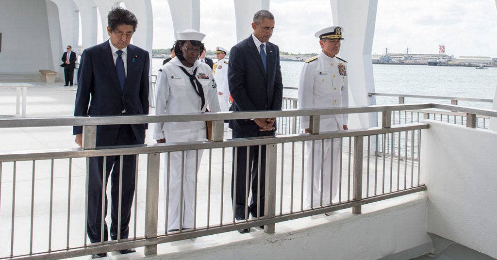 Japanese Prime Minister, Shinzo Abe, Yeoman 2nd Class Michelle Wrabley, assigned to U.S. Pacific Fleet, President of the United States, Barack Obama, and U.S. Pacific Command Commander, Adm. Harry Harris pause to honor the service members killed during the Dec. 7, 1941 attacks on Pearl Harbor. Abe is the first Japanese prime minister to visit the USS Arizona Memorial. (U.S. Navy photo by Mass Communication Specialist 1st Class Jay M. Chu/Released)