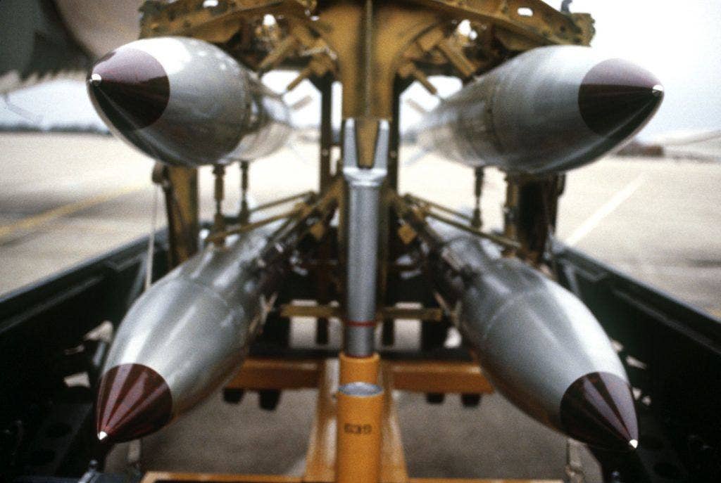 A frontal view of four B-61 nuclear free-fall bombs on a bomb cart at Barksdale Air Force Base. | Department of Defense photo by SSGT Phil Schmitten