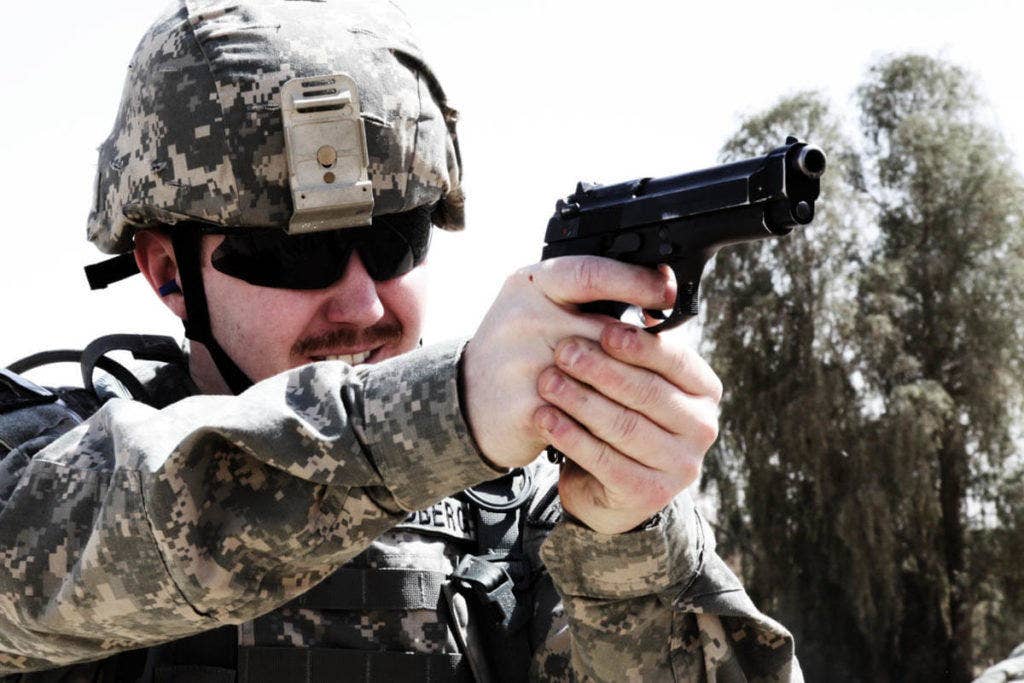 A soldier fires a Beretta M9 pistol. | US Army photo