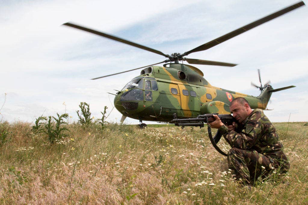 A Romanian IAR 330 Puma helicopter employs perimeter defense while it extracts a joint team of forces from both the 1st Squadron, 131st Cavalry, Alabama Army National Guard, and the 528th Light Reconnaissance Battalion, Romanian Land Force, as they complete a long range surveillance training mission for Operation Red Dragon on June 18, 2015, near Babadag Training Area, Romania. (Photo: U.S. Army Staff Sgt. Christopher Shanley)