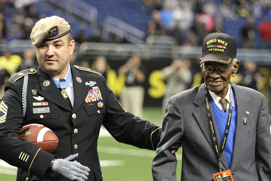 January 3: Medal of Honor recipient retired Master Sgt. Leroy Petry walks onto the field of the Alamodome in San Antonio with World War II veteran Richard Overton in San Antonio. Petry, awarded the Medal of Honor last year for efforts in Afghanistan, and Overton, the oldest living World War II veteran at 108 years old, delivered the game ball at the U.S. Army All-American Bowl. | US Army photo by Sgt. 1st Class Brian Hamilton