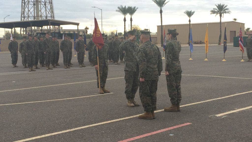 Marine Corps Sgt. Gabriel R. McInnis, center, engineer equipment mechanic with Bulk Fuel Company C, 6th Engineer Support Battalion, 4th Marine Logistics Group, receives a Navy and Marine Corps Achievement Medal at Luke Air Force Base, Ariz., Jan. 7, 2017. McInnis received the medal for his actions in preventing an assault of a family in Tempe, Ariz., Dec. 27, 2016. | US Marine Corps photo by Sgt. Ian Leones