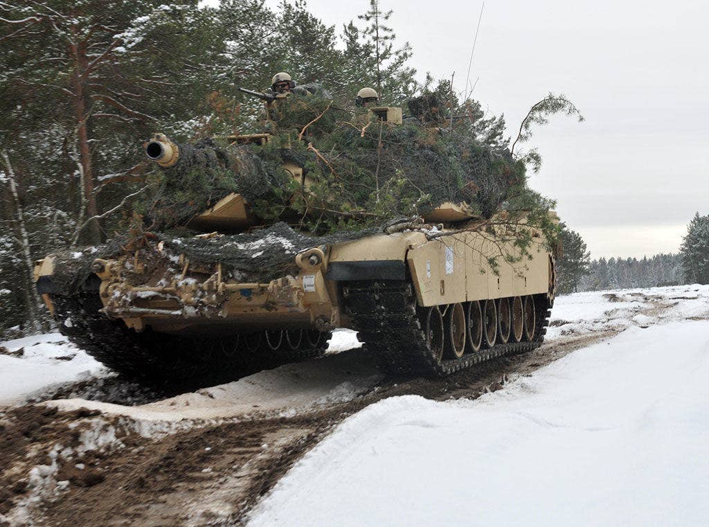 An M1 Abrams tank emerges out of wooded terrain after soldiers assigned to the 4th Infantry Division's 1st Battalion, 68th Armor Regiment, 3rd Armored Brigade Combat Team had concealed it to blend in with the surrounding environment at Presidential Range in Swietozow, Poland, Jan. 20, 2017. The vehicles and soldiers are part of a nine-month deployment in support of Operation Atlantic Resolve. (U.S. Army photo by Staff Sgt. Elizabeth Tarr)