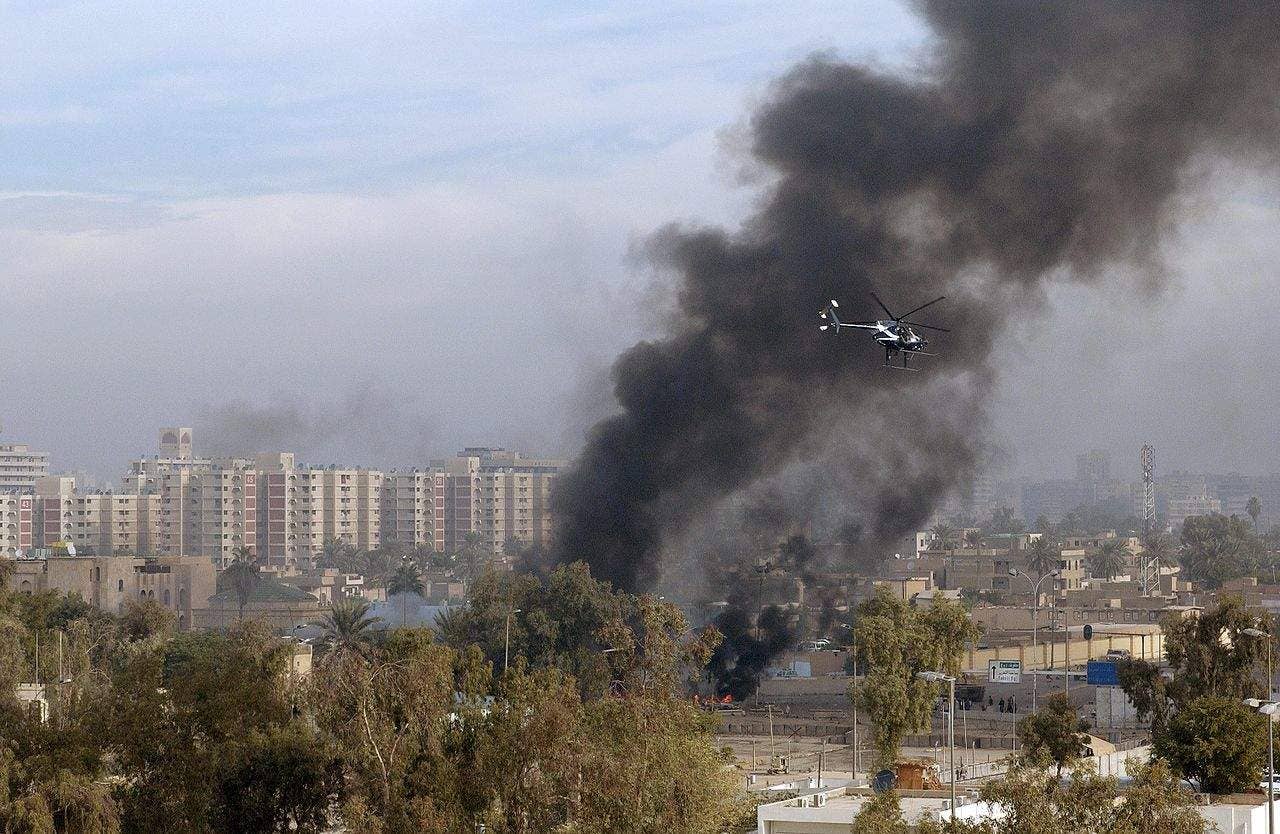 A Blackwater Security Company MD-530F helicopter aids in securing the site of a car bomb explosion in Baghdad, Iraq, on December 4, 2004, during Operation IRAQI FREEDOM. A similar bombing in 2007 lead to the incident that resulted in Blackwater contractors facing charges of manslaughter. (USAF photo)