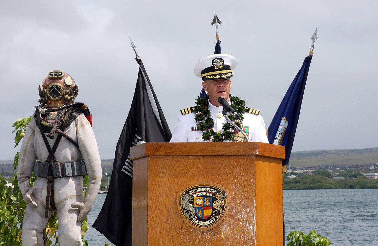 Cmdr. Daniel M. Colman, commanding officer of the Pearl Harbor-based Mobile Diving and Salvage Unit One (MDSU) 1, address attendees during a change of command ceremony at the USS Utah Memorial on Ford Island. Colman was being relieved by Cmdr. John B. Moulton. The MDSU-1 mission is to provide combat ready, expeditionary, rapidly deployable Mobile Diving and Salvage Detachments (MDSD) to conduct harbor clearance, salvage, underwater search and recovery, and underwater emergency repairs in any environment. The suit to Colman's left is similar to one used by Ken Hartle, who died Jan. 24 at the age of 103, during salvage operations at Pearl Harbor in World War II. (U.S. Navy photo by Chief Mass Communication Specialist David Rush)