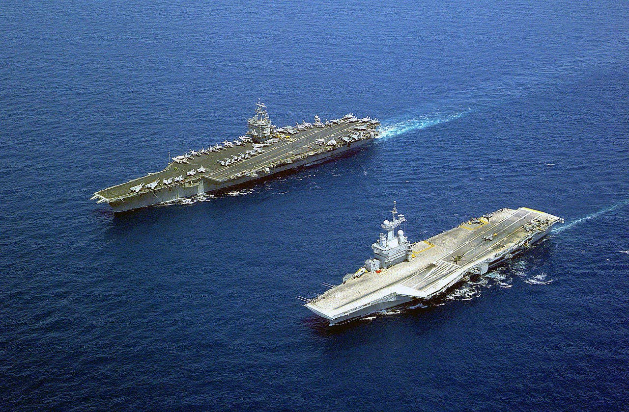The U.S. Navy aircraft carrier USS Enterprise (CVN-65), the world's first nuclear-powered aircraft carrier, steams alongside the French aircraft carrier Charles De Gaulle (R 91). One of these carriers could launch aircraft equipped with a long-range nuclear-tipped missile - and it isn't the Big E. (US Navy photo)