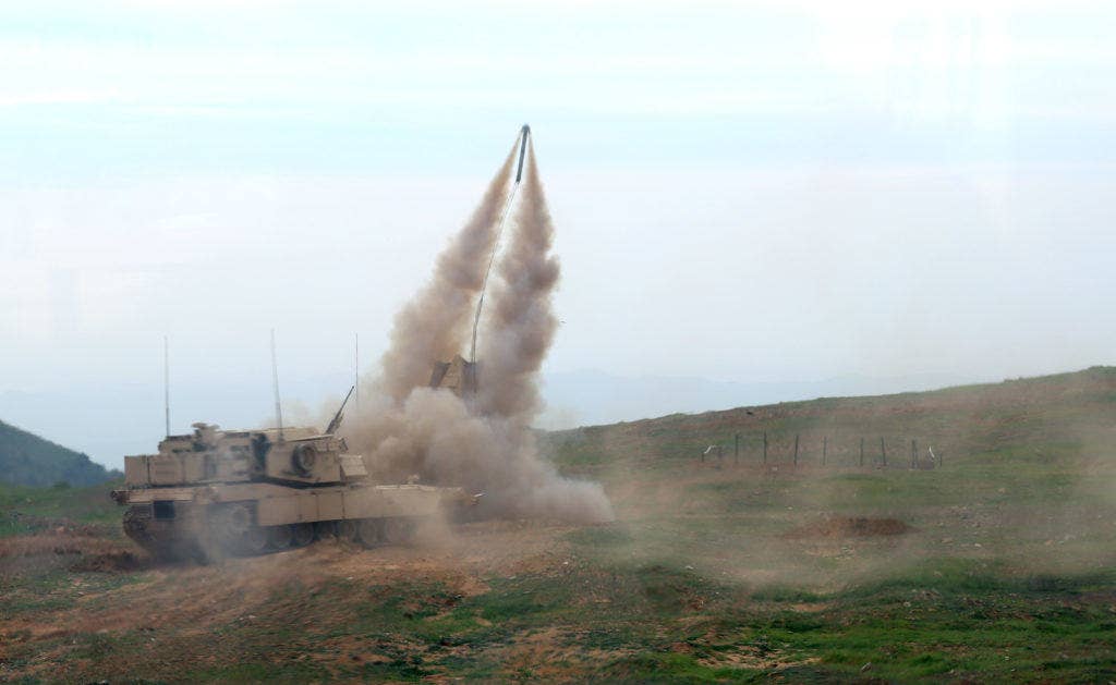 A U.S. Marine Corps Assault Breacher Vehicle (ABV) assigned to 1st Combat Engineer Battalion (CEB) launches a Mine Clearing Line Charge (MCLC) on range 600 at Camp Pendleton, Calif., Feb. 20, 2015. Armed with approximately 7,000 pounds of C4 explosives and a mine resistant Titanium-plated undercarriage, the ABV ensures Marines can maneuver on the battlefield despite enemy minefields. (Photo: U.S. Marine Corps Warrant Officer Wade Spradlin)