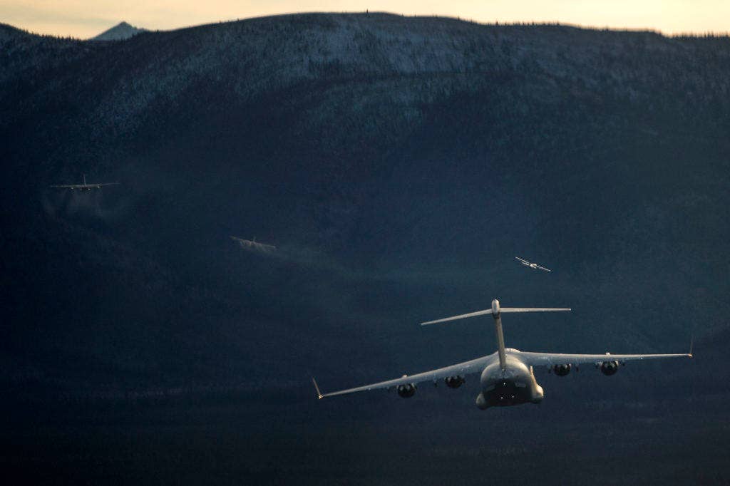 A U.S. Air Force C-17 Globemaster III from Joint Base Elmendorf-Richardson flies behind several C-130J Hercules during a training sortie, Oct. 19, 2016. Training sorties are imperative to pilot development and overall mission effectiveness. (Photo: U.S. Air Force Staff Sgt. James Richardson)