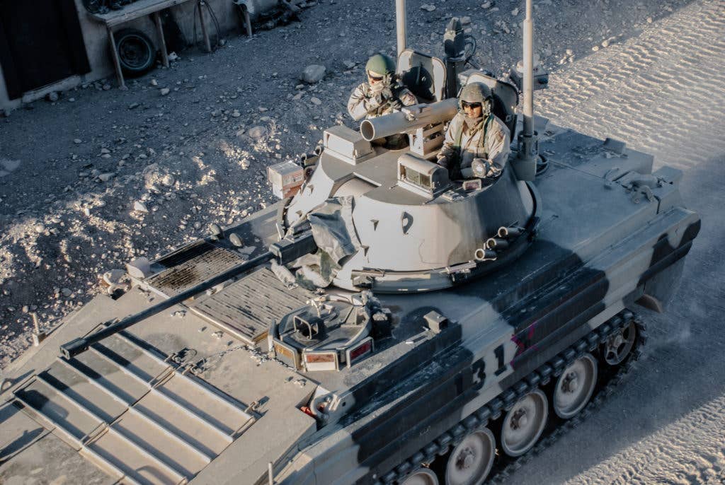 An OPFOR Surrogate Vehicle from Coldsteel Troop, 1st Squadron, 11th Armored Cavalry Regiment, travels through the city of Dezashah en route to the objective, during NTC rotation 17-01, at the National Training Center, Oct. 7, 2016. The purpose of this phase of the rotation was to challenge the Greywolf Brigade's ability to conduct a deliberate defense of an area while being engaged by conventional and hybrid threats. (Photo: U.S. Army Sgt. David Edge)