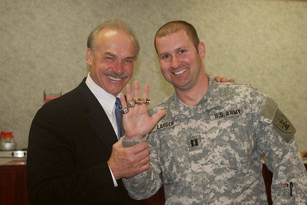 Vietnam Veteran and former Pittsburgh Steeler Rocky Bleier poses with Capt. Doug Larsen who tries on Bleier's four Super Bowl rings at the North Dakota National Guard's 2009 Safety Conference in Bismarck Jan 24. (US Army photo)