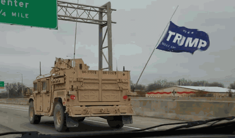 A Trump flag flying from the lead vehicle as SEALs convoy between two training locations. (Video screenshot)