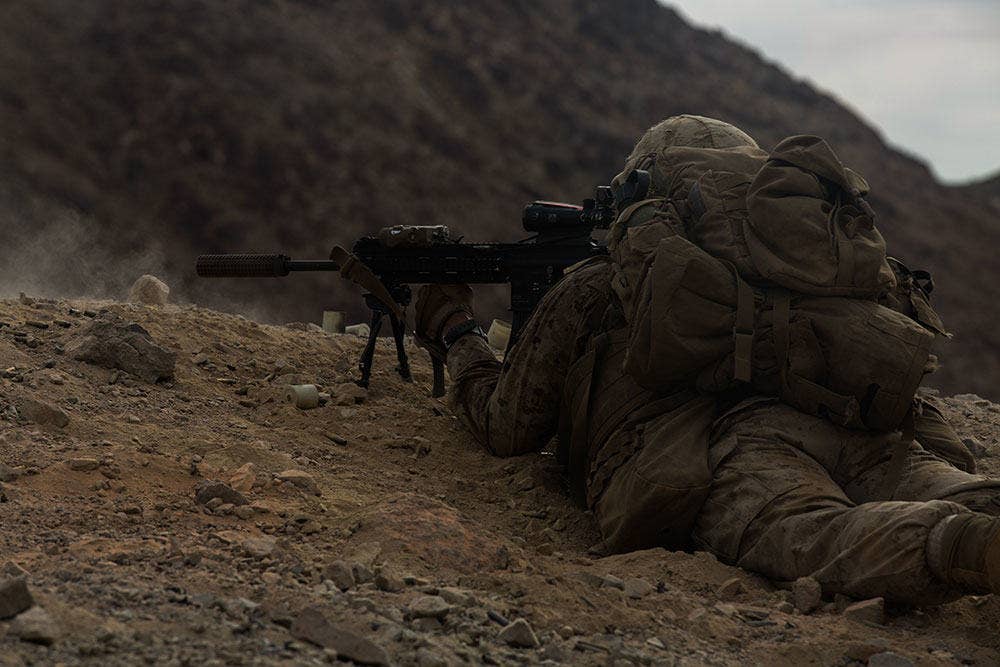 Suppressors help with followup shots for precision shooters like this Marine firing an M27 rifle. (US Marine Corps photo)