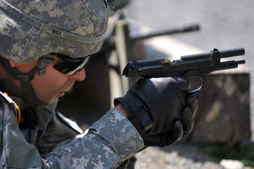 A soldier fires an M9 pistol. | U.S. Army photo