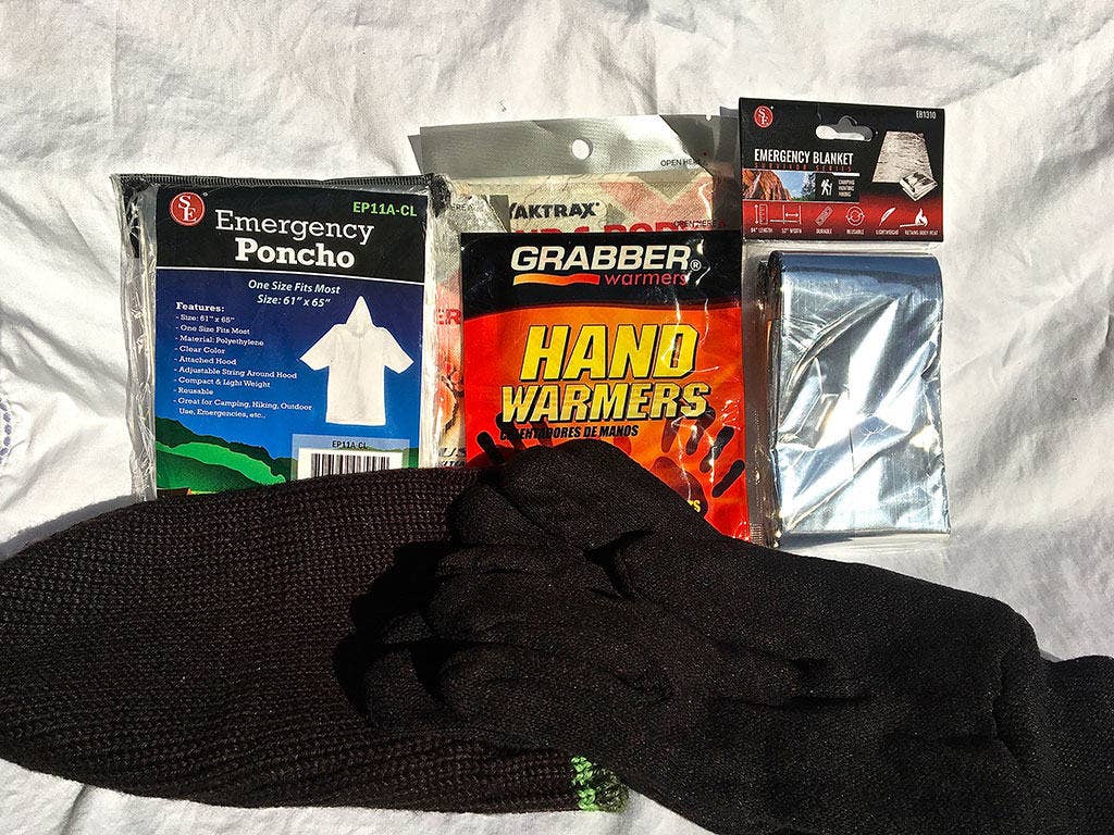 Everyone needs to stay warm and dry. Chemically activated hand and body warmers, gloves, a ski cap, an emergency blanket, and a folding poncho are easy to find and relatively small.