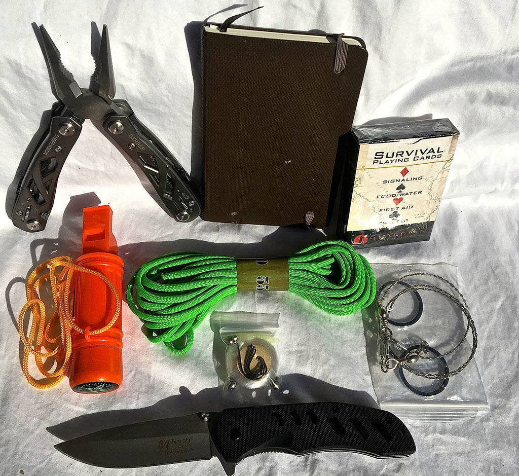 A Gerber or other multi tool is a must as is a good pocket knife. I like to pack a small shovel, a tree saw, a fishing kit, and a Mace gun with extra cartridges. I also have a multi-use bracelet on the outside of the bag with a compass, cord and flint.