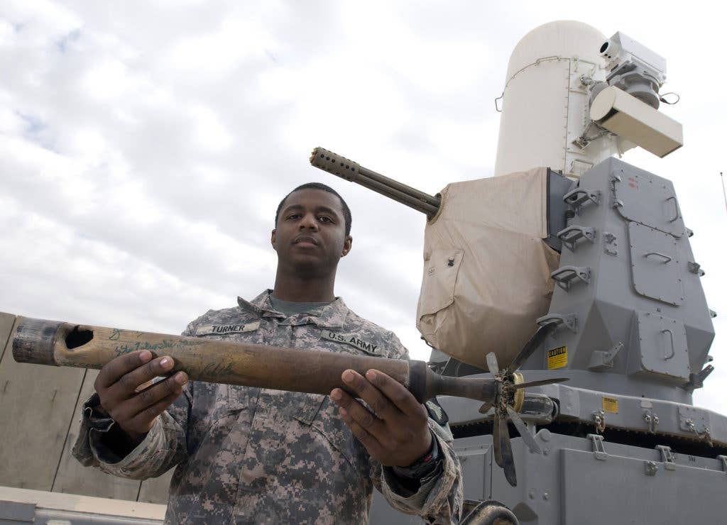 Specialist. Jamael O. Turner, of Nashville, Tenn., shows one of the first rockets his unit shot down with the counter rocket artillery and mortar at Joint Base Balad, Iraq. (Photo: U.S. Army)