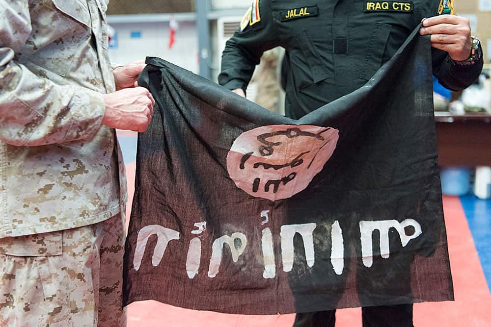 Members from the Iraqi Counter Terrorism Service present Marine Gen. Joseph F. Dunford, chairman of the Joint Chiefs of Staff, with a flag from Bartilah, a town recaptured just outside of Mosul from ISIS. | DoD Photo by Navy Petty Officer 2nd Class Dominique A. Pineiro